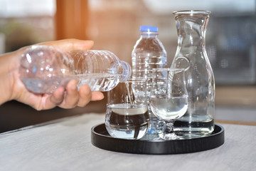 Drinking water with incedent morning sunlight pour into the the clear glasses