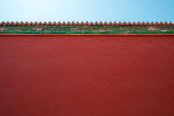 Chinese traditional red wall with blue sky. Minimal background.