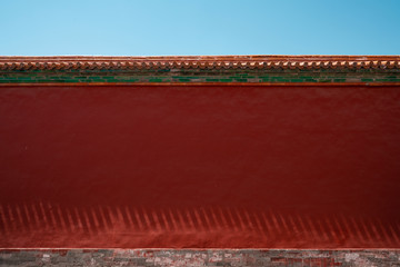Chinese traditional red wall with blue sky. Minimal background.
