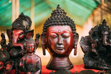 Goa, India. Traditional Store With Statues Different Colors And Sizes. Statues Of Buddha Head And Ganesha On Market