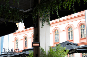 Cafe in Serbia with Orange and White Building in Background
