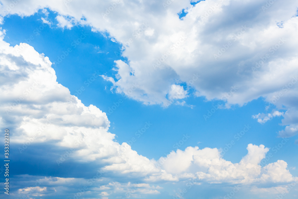 Wall mural large clouds in blue sky on sunny spring day