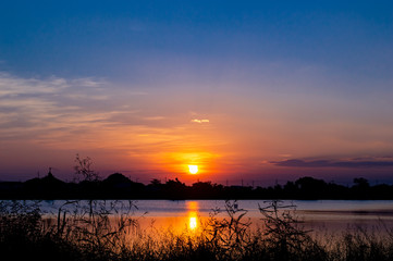 Fototapeta premium landscape silhouette sunset in to river with blue sky