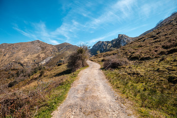 View of beautiful mountain landscape on a sunny day. Mountain dirt road in National park Picos de Europa. Cantabria, Spain, Europe