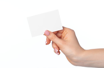 Female hand with blank white business card isolated on white