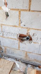 Demolition of an old bathroom with removal of the tiles and exposure of the water and drainage pipes