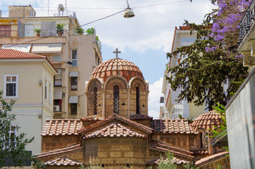 Interior view of Greek Orthodox church or basilica in Athens, Greece with murals and religious wall...
