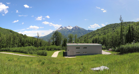 Beautiful futuristic modern water intake pumping wells against the background of mountains and snow peaks. Sochi, Russia.