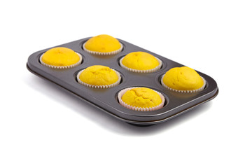 Obraz na płótnie Canvas Cupcakes in baking tray isolated on white background. Homemade bakery. Pumpkin muffins