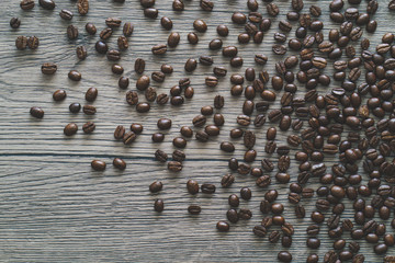 Fototapeta premium Coffee beans. On a wooden background. Top view