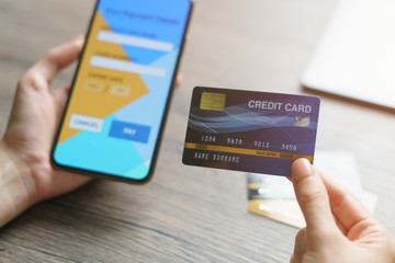 Online shopping concept : woman hands holding cradit card and using credit card online shopping.