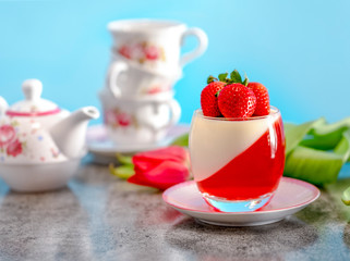 strawberry panna cotta on blue background