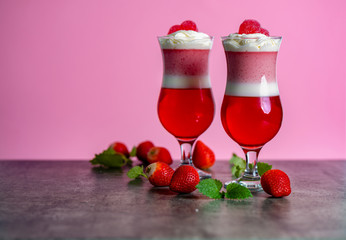 strawberry panna cotta with whipped cream in two glasses