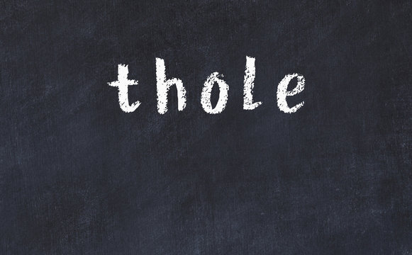 College chalk desk with the word thole written on in