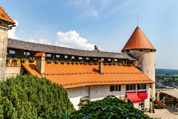 Bled Castle and it's orange roofs. Medieval castle built from stone on a precipice above the Lake Bled in Slovenia