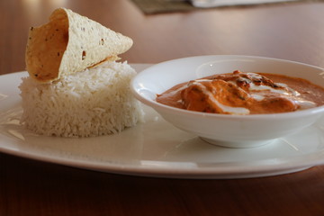 SMOKED CHICKEN BUTTER MASALA, TANDOORI MARINATED SUCCULENT CHICKEN COOKE IN SMOKED TOMATO AND CASHEW NUT GRAVY SERVED WITH STEAMED BASMATI RICE