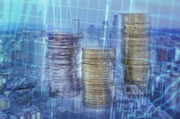 Stacks of coins with a business chart. Double exposure. Digital editing. Concept of savings, taxes or economy. The economic crisis. Rising or falling income.