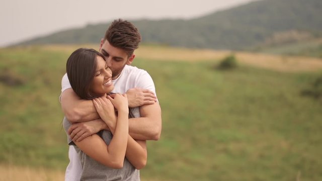 Pretty young couple in love outside in spring nature