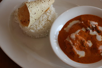 SMOKED CHICKEN BUTTER MASALA, TANDOORI MARINATED SUCCULENT CHICKEN COOKE IN SMOKED TOMATO AND CASHEW NUT GRAVY SERVED WITH STEAMED BASMATI RICE
