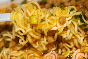 Cooked instant noodles with spices, dried vegetables and freeze-dried meat. Close up.