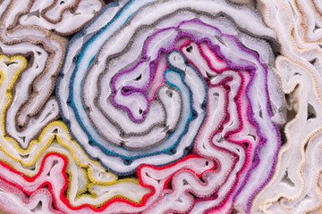 Obraz premium Twisted pieces of multi-colored fabric. Samples of furniture fabric in a roll. Abstract background from bright fabrics.