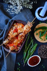 pork kebab with rice and vegetables on dark background