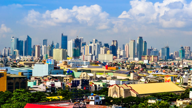 Paranaque, Metro Manila, Philippines - Jan 2016: Baclaran Church with Makati Skyline in background.