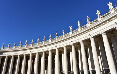 Bernini&rsquo;s Colonnade and statues at St. Peter&rsquo;s Square with blue sky. Vatican City, Rome, Italy.