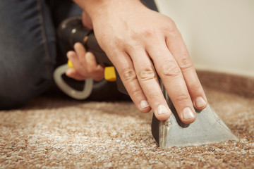 Detail of cleaning deeply carpet with wet and dry cleaning machine