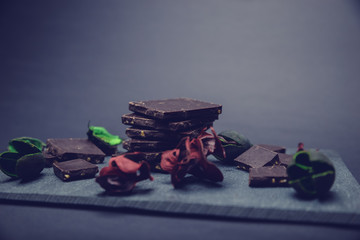 peaces of chocolate on stone plate