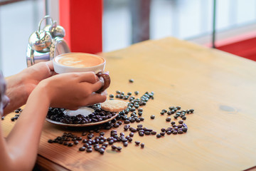 Soft Light,A businesswoman is holding a cup of coffee to drink hot coffee in the morning to prepare before starting to work at home.Stimulating yourself for work in the morning by drinking coffee