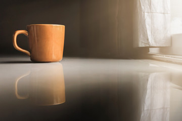 Smooth Focus and soft Focus,Hot coffee in a cup of coffee placed on the bedroom floor by the window in the morning was placed to prepare for drinking coffee before work.