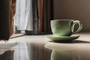 Smooth Focus and soft Focus,Hot coffee in a cup of coffee placed on the bedroom floor by the window in the morning was placed to prepare for drinking coffee before work.