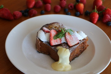 French Toast, Baked brioche layered with whipped cream,
strawberry, nuts and cream anglaise 