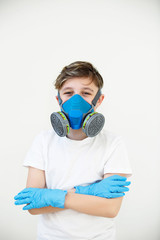 coronavirus protection.Boy in a respirator mask . latex gloves on a white background. Air mask for face. Coronavirus mask.For healthcare design.Breathing respirator mask