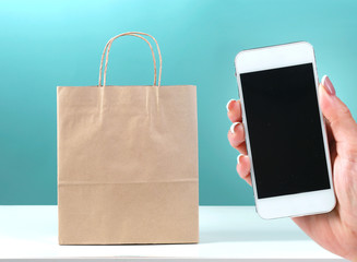 Online shopping,e-commerce.Bag and phone screen in hand.Internet shop online order.