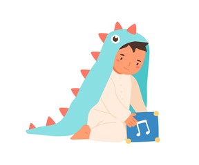 Cute little boy wearing dinosaur costume playing with music box vector flat illustration. Adorable toddler in romper suit sitting with toy cube isolated on white. Lovely child in funny apparel