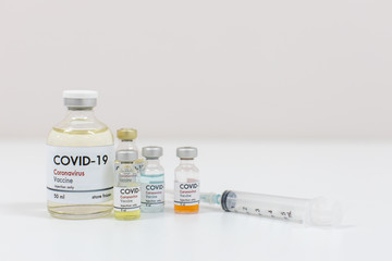 Concept of a Coronavirus covid -19 trial Multiple Vaccine Bottles with Needles and Stethoscope.