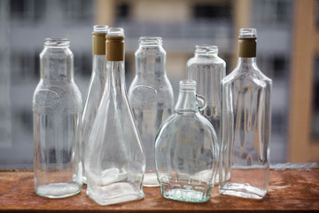several glass bottles and cans of various shapes