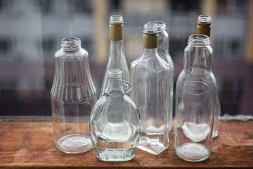 several glass bottles and cans of various shapes