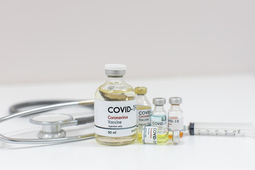 Concept of a Coronavirus covid -19 trial Multiple Vaccine Bottles with Needles and Stethoscope.