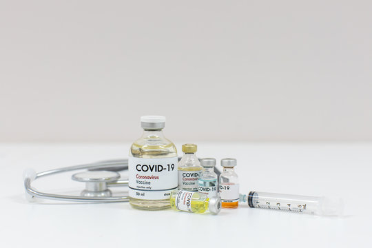 Concept Of A Coronavirus Covid -19 Trial Multiple Vaccine Bottles With Needles And Stethoscope.