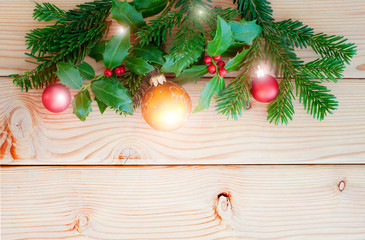 Christmas border on wooden background. Branch of fir and holly