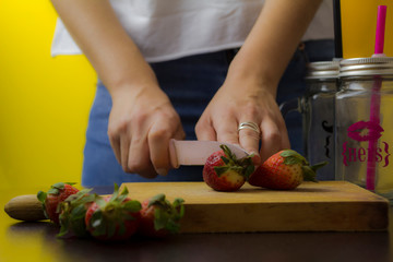 Woman hands holding fresh strawberries.