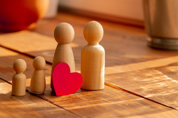 Small wooden figures of family members. Family relationship symbol