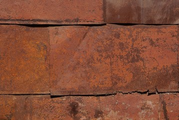 metal texture of rusty red brown iron wall with a seam