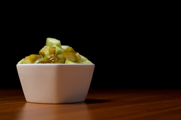 Vegetables in white bowls, diced on a brown kitchen table. Peppers, cucumbers, sweet corn and peas in a bowl on the table. - obrazy, fototapety, plakaty