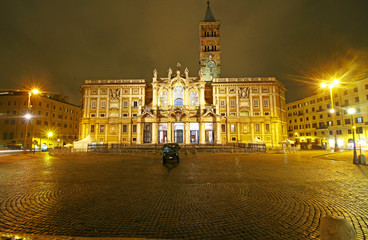 Fototapeta premium Rome, Italy - March, 07, 2018: Façade of Papal Basilica di Santa Maria Maggiore with anciaent mosaics facing the Piazza at night. Charming place in Eternal city. Vacation abroad in heart of old Europe