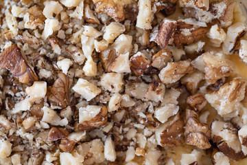 close up of crushed walnuts as food background or texture