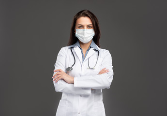 Female medic in protective mask in studio